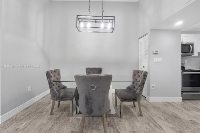 469 NE 207th Ln Unit 205, Miami, FL 33179 - dining space featuring wood finish floors and baseboards