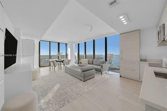 650 NE 32nd St Unit 3708, Miami, FL 33137 - living area with floor to ceiling windows and light wood-style floors