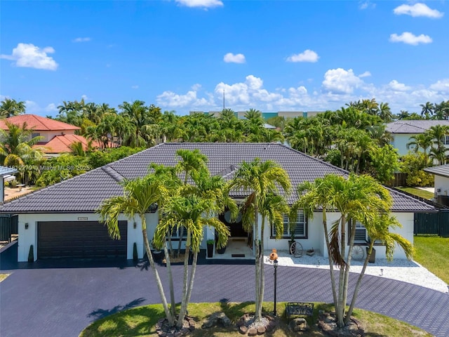 15760 SW 45th St, Miami, FL 33185 - view of front of home featuring asphalt driveway, a tile roof, an attached garage, and stucco siding