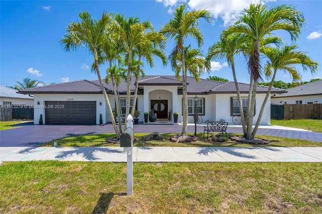 15760 SW 45th St, Miami, FL 33185 - mediterranean / spanish house featuring stucco siding, driveway, a garage, and a tiled roof