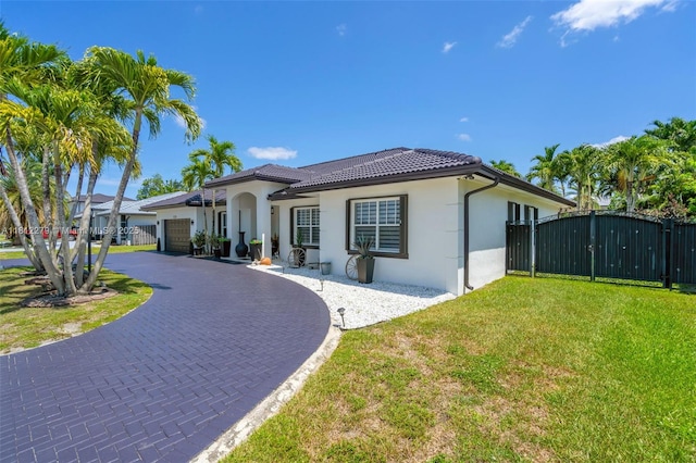 15760 SW 45th St, Miami, FL 33185 - mediterranean / spanish home with a gate, driveway, a garage, stucco siding, and a tiled roof