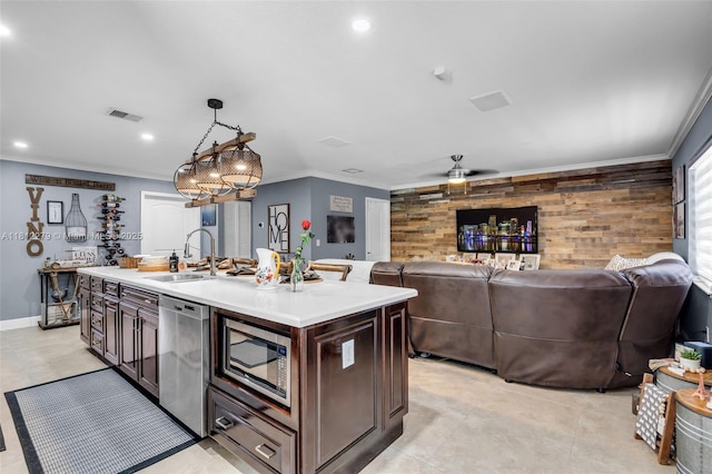 15760 SW 45th St, Miami, FL 33185 - kitchen featuring stainless steel appliances, a sink, light countertops, ornamental molding, and ceiling fan