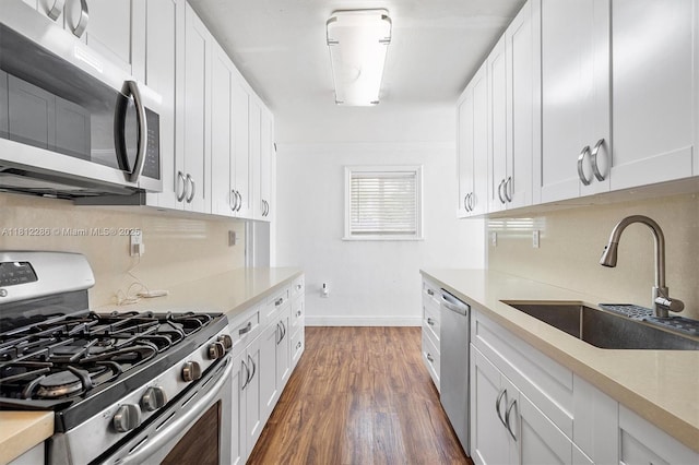 840 N 68th Ter, Hollywood, FL 33024 - kitchen with appliances with stainless steel finishes, a sink, baseboards, white cabinets, and dark wood-style flooring