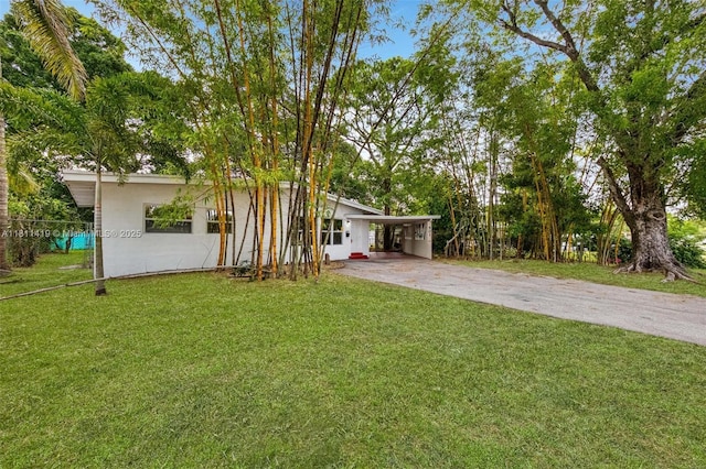 501 Carolina Ave, Fort Lauderdale, FL 33312 - view of grassy yard with driveway and an attached carport