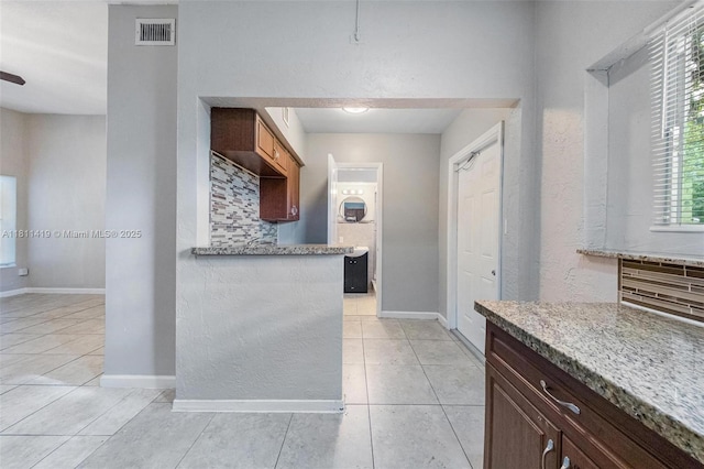 501 Carolina Ave, Fort Lauderdale, FL 33312 - kitchen with light tile patterned flooring, tasteful backsplash, baseboards, and light stone counters