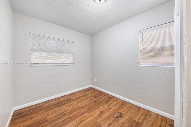501 Carolina Ave, Fort Lauderdale, FL 33312 - empty room featuring baseboards, wood finished floors, a textured wall, and a textured ceiling