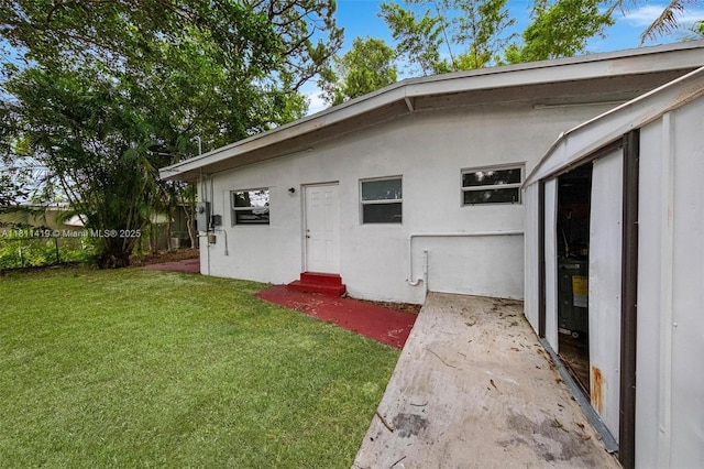 501 Carolina Ave, Fort Lauderdale, FL 33312 - rear view of property with entry steps, a yard, and stucco siding