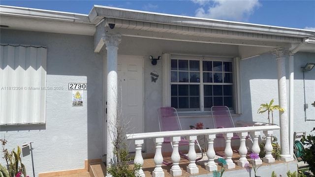 3351 SW 28th St, Miami, FL 33133 - entrance to property featuring stucco siding and covered porch