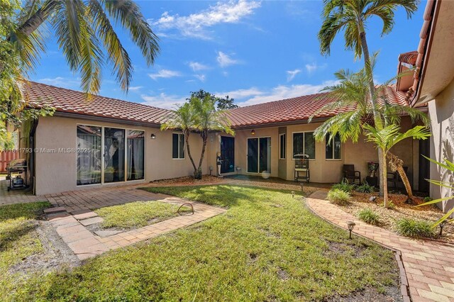 14520 SW 37th St, Miramar, FL 33027 - back of property with a tile roof, stucco siding, and a lawn