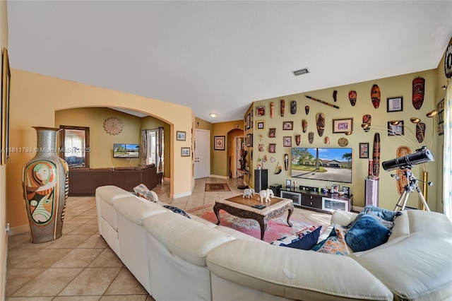 14520 SW 37th St, Miramar, FL 33027 - living area featuring arched walkways, light tile patterned floors, and baseboards