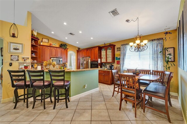 14520 SW 37th St, Miramar, FL 33027 - dining room with a chandelier, light tile patterned flooring, vaulted ceiling, recessed lighting, and baseboards