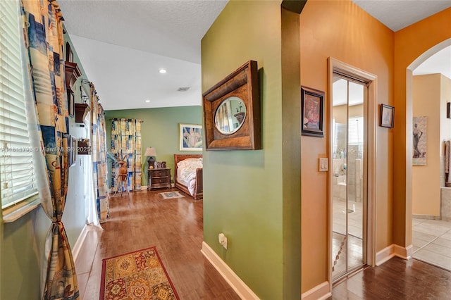 14520 SW 37th St, Miramar, FL 33027 - corridor featuring arched walkways, wood finished floors, and baseboards