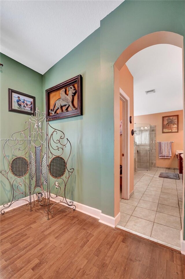 14520 SW 37th St, Miramar, FL 33027 - hall featuring arched walkways, light wood finished floors, and baseboards