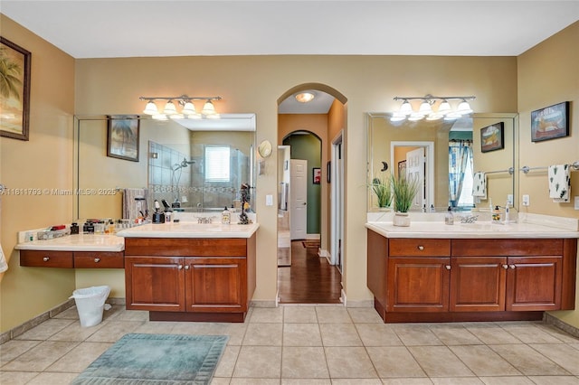 14520 SW 37th St, Miramar, FL 33027 - full bath with a tile shower, two vanities, tile patterned flooring, and baseboards