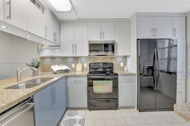 1709 Whitehall Dr Unit 401, Davie, FL 33324 - kitchen with black appliances, a sink, light tile patterned floors, backsplash, and recessed lighting