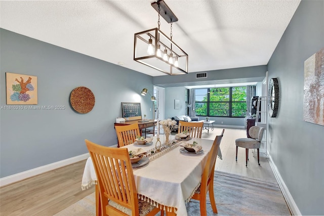 1709 Whitehall Dr Unit 401, Davie, FL 33324 - dining room featuring wood finished floors, a textured ceiling, and baseboards