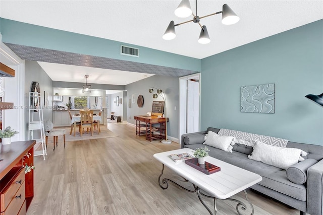 1709 Whitehall Dr Unit 401, Davie, FL 33324 - living room with light wood finished floors, a chandelier, and baseboards