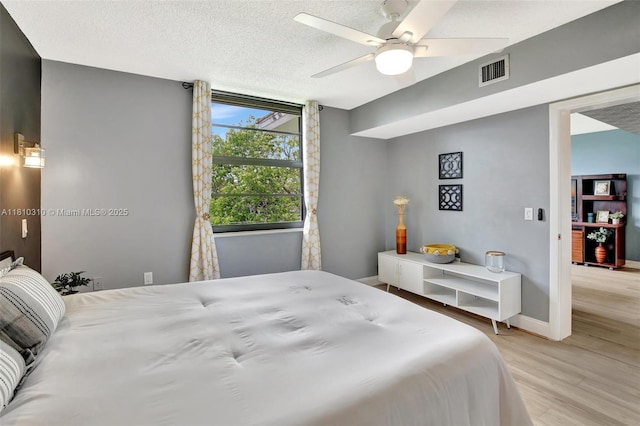 1709 Whitehall Dr Unit 401, Davie, FL 33324 - bedroom featuring wood finished floors, baseboards, a ceiling fan, and a textured ceiling