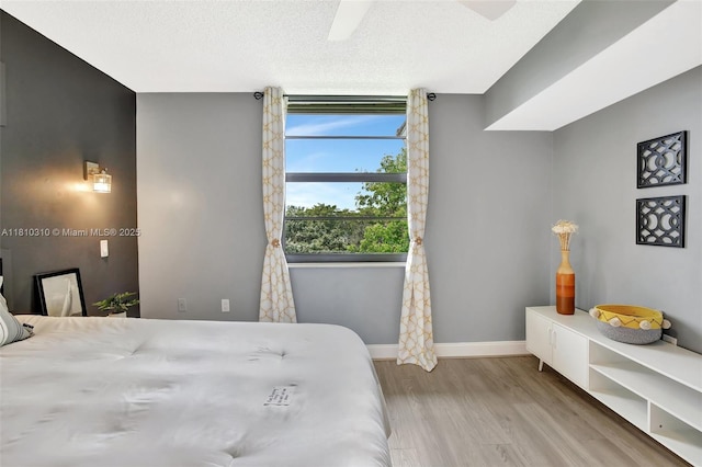 1709 Whitehall Dr Unit 401, Davie, FL 33324 - bedroom featuring wood finished floors, baseboards, ceiling fan, and a textured ceiling