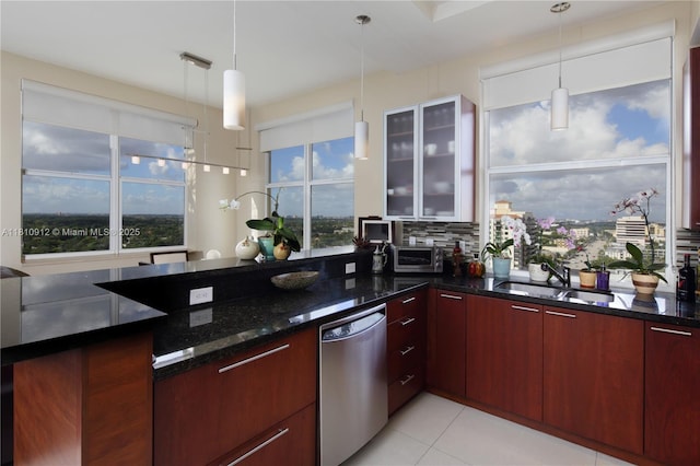 1607 Ponce De Leon Blvd Unit 12E, Coral Gables, FL 33134 - kitchen featuring stainless steel dishwasher, a sink, dark stone countertops, glass insert cabinets, and modern cabinets