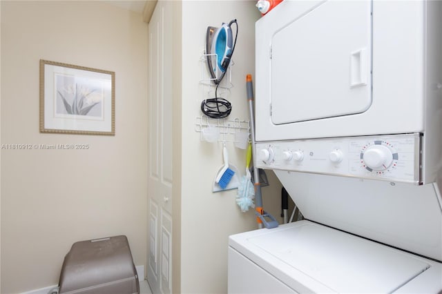 1607 Ponce De Leon Blvd Unit 12E, Coral Gables, FL 33134 - laundry room featuring stacked washing machine and dryer and baseboards