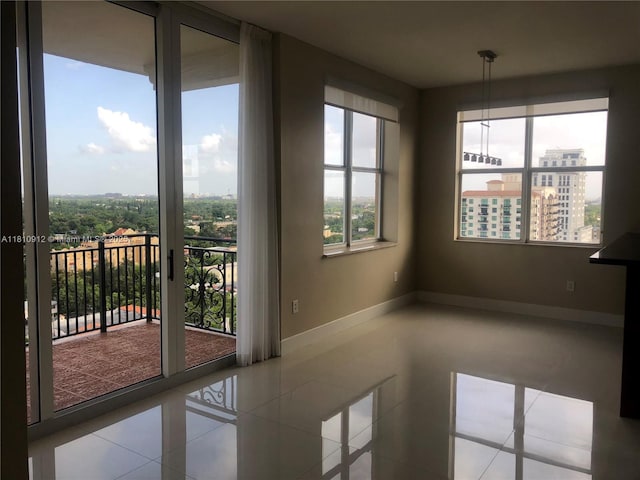 1607 Ponce De Leon Blvd Unit 12E, Coral Gables, FL 33134 - tiled empty room featuring baseboards