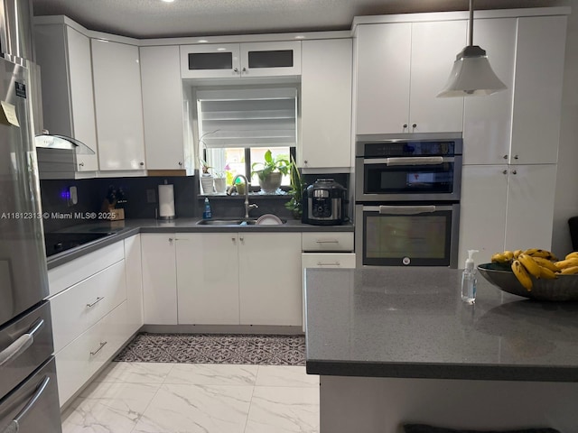 3297 W 70th St, Hialeah, FL 33018 - kitchen with appliances with stainless steel finishes, dark countertops, a sink, white cabinets, and light marble finish floors