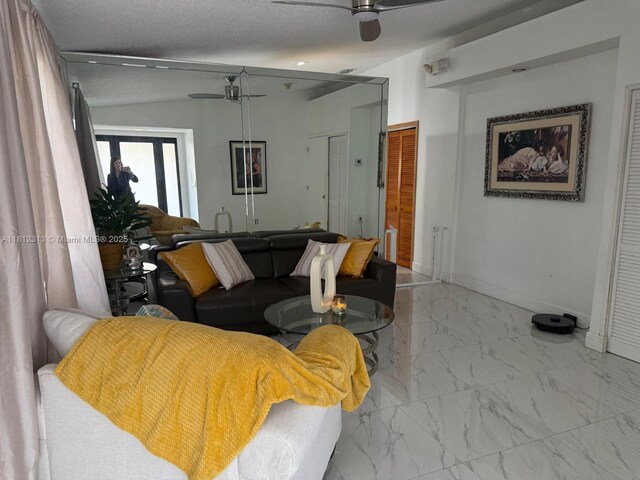 3297 W 70th St, Hialeah, FL 33018 - living room featuring ceiling fan, marble finish floors, baseboards, and lofted ceiling