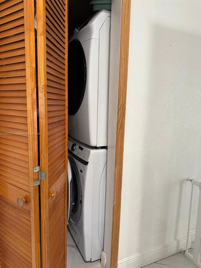 3297 W 70th St, Hialeah, FL 33018 - laundry room with stacked washer / drying machine and baseboards
