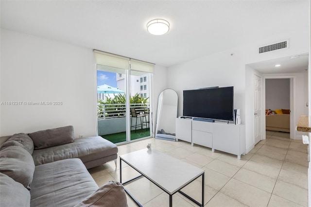 1723 SW 2nd Ave Unit 502, Miami, FL 33129 - living room featuring expansive windows and light tile patterned flooring