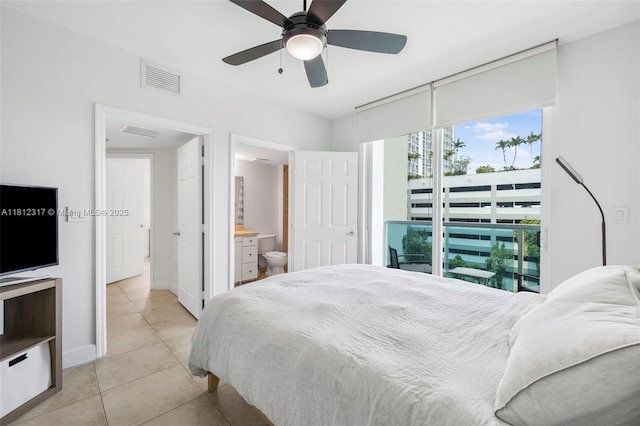1723 SW 2nd Ave Unit 502, Miami, FL 33129 - bedroom with light tile patterned floors, ceiling fan, and connected bathroom