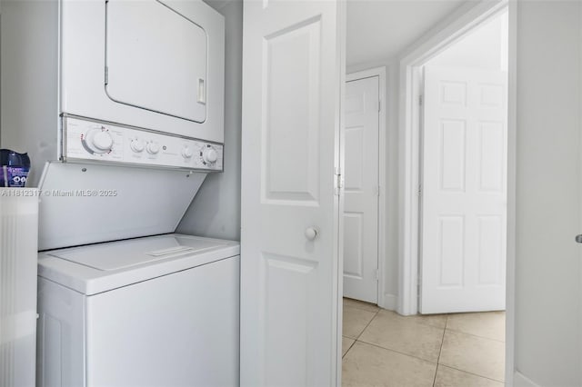 1723 SW 2nd Ave Unit 502, Miami, FL 33129 - washroom with estacked washer and dryer and light tile patterned floors