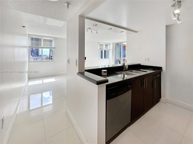 850 N Miami Ave Unit W-1903, Miami, FL 33136 - kitchen with dishwasher, track lighting, light tile patterned floors, dark countertops, and a textured ceiling