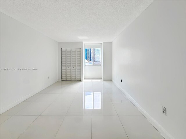 850 N Miami Ave Unit W-1903, Miami, FL 33136 - spare room with a textured ceiling, baseboards, and light tile patterned floors