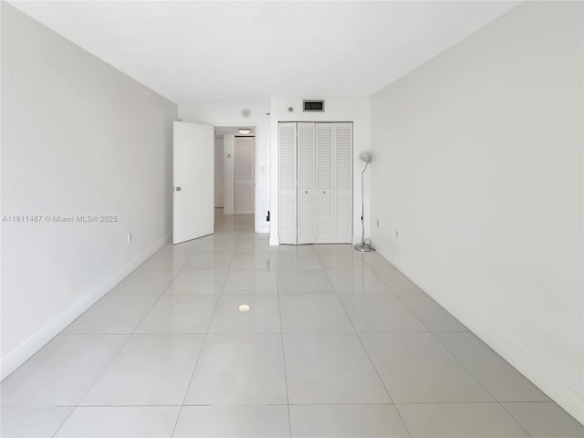 850 N Miami Ave Unit W-1903, Miami, FL 33136 - unfurnished bedroom with baseboards, light tile patterned flooring, and a closet