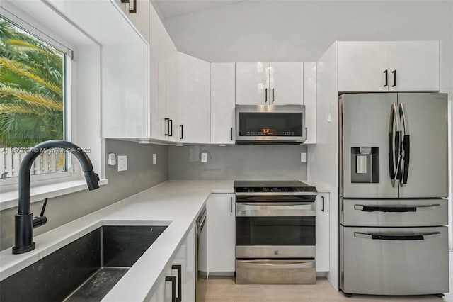731 Briarwood Ter, Davie, FL 33325 - kitchen featuring appliances with stainless steel finishes, a sink, white cabinets, light countertops, and modern cabinets
