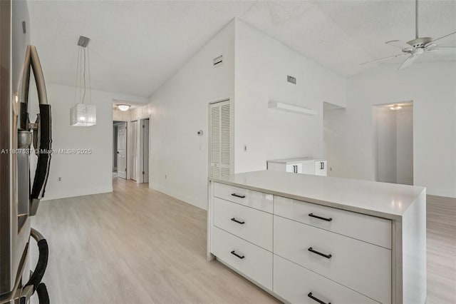 731 Briarwood Ter, Davie, FL 33325 - kitchen with vaulted ceiling, stainless steel fridge with ice dispenser, ceiling fan, light wood finished floors, and white cabinetry