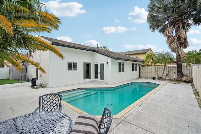 731 Briarwood Ter, Davie, FL 33325 - view of swimming pool featuring french doors, a patio area, a fenced backyard, and central AC