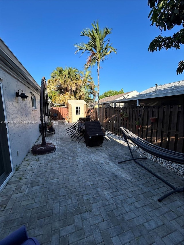 12680 SW 144th Ter, Miami, FL 33186 - fenced backyard with a shed and a patio