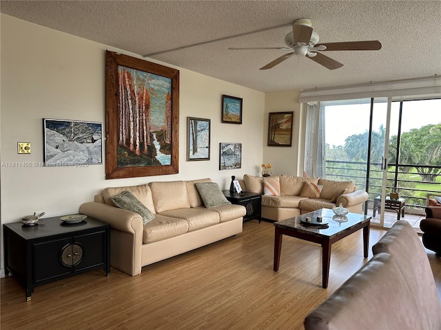 1100 NW Saint Charles Pl Unit 411, Pembroke Pines, FL 33026 - living area featuring a textured ceiling, ceiling fan, and wood finished floors