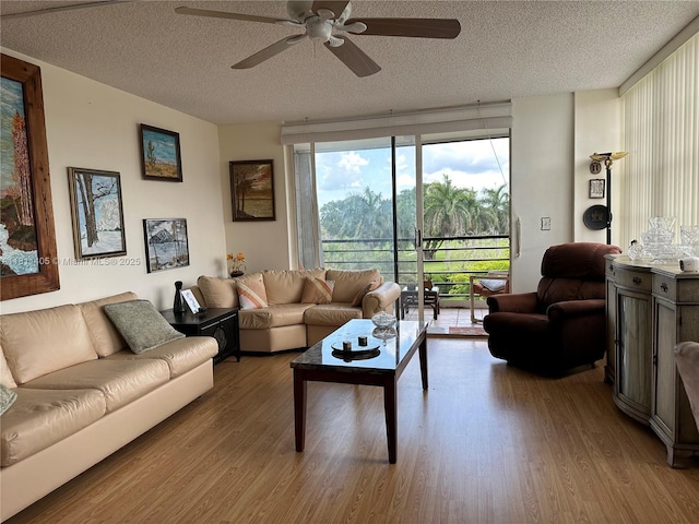 1100 NW Saint Charles Pl Unit 411, Pembroke Pines, FL 33026 - living room with a textured ceiling, wood finished floors, and a ceiling fan