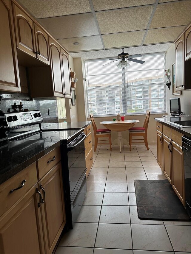 1100 NW Saint Charles Pl Unit 411, Pembroke Pines, FL 33026 - kitchen featuring black appliances, ceiling fan, decorative backsplash, dark countertops, and a paneled ceiling