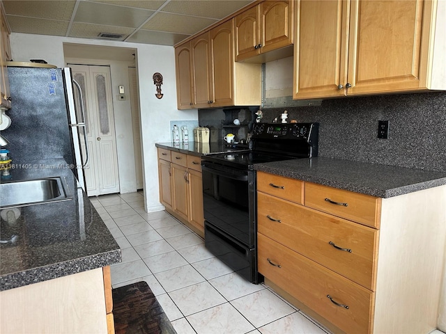 1100 NW Saint Charles Pl Unit 411, Pembroke Pines, FL 33026 - kitchen featuring black electric range, dark countertops, backsplash, a paneled ceiling, and freestanding refrigerator