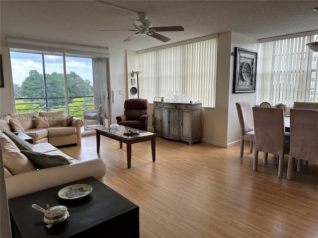 1100 NW Saint Charles Pl Unit 411, Pembroke Pines, FL 33026 - living area featuring ceiling fan, light wood-style flooring, a textured ceiling, and baseboards
