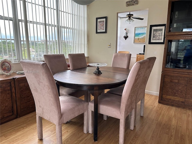 1100 NW Saint Charles Pl Unit 411, Pembroke Pines, FL 33026 - dining area with ceiling fan, light wood-style floors, and baseboards