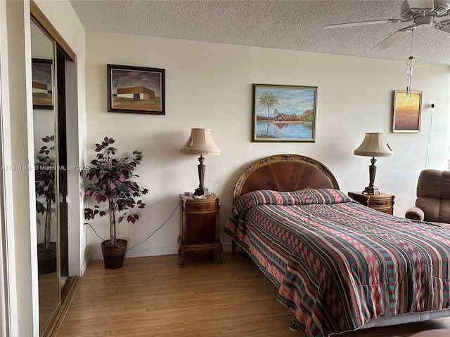 1100 NW Saint Charles Pl Unit 411, Pembroke Pines, FL 33026 - bedroom with wood finished floors, a textured ceiling, and baseboards