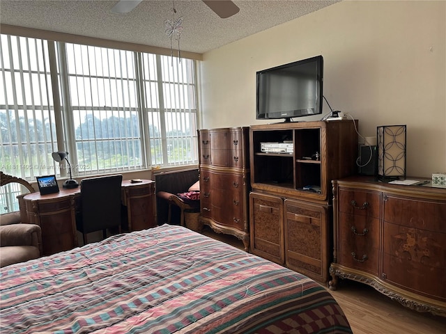 1100 NW Saint Charles Pl Unit 411, Pembroke Pines, FL 33026 - bedroom featuring wood finished floors, a textured ceiling, and ceiling fan