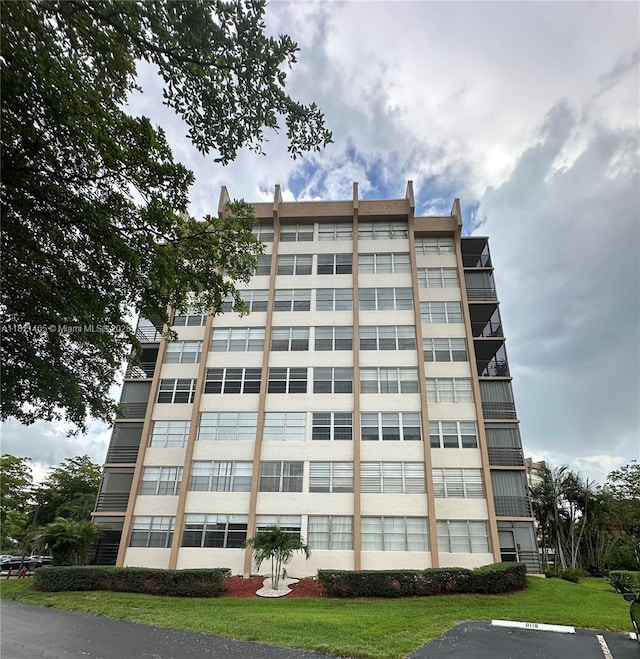 1100 NW Saint Charles Pl Unit 411, Pembroke Pines, FL 33026 - view of building exterior featuring uncovered parking