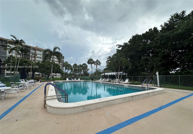 1100 NW Saint Charles Pl Unit 411, Pembroke Pines, FL 33026 - community pool featuring a patio
