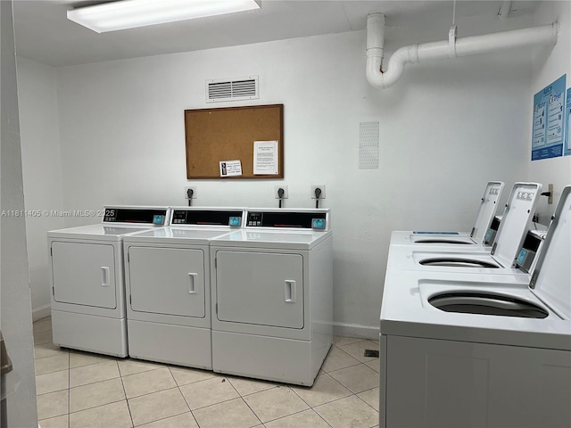 1100 NW Saint Charles Pl Unit 411, Pembroke Pines, FL 33026 - community laundry with separate washer and dryer, light tile patterned floors, and baseboards
